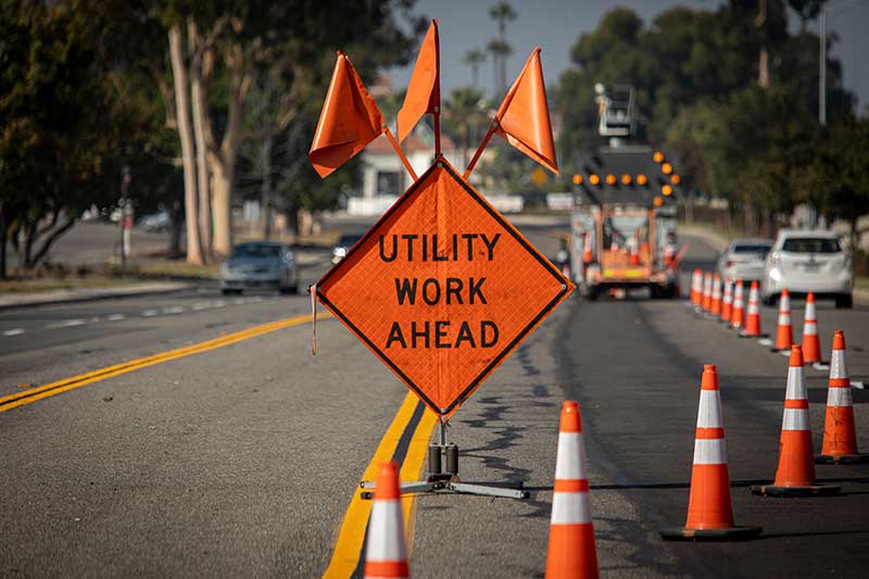 atssa certified flagger course utility work ahead sign with flags at road construction